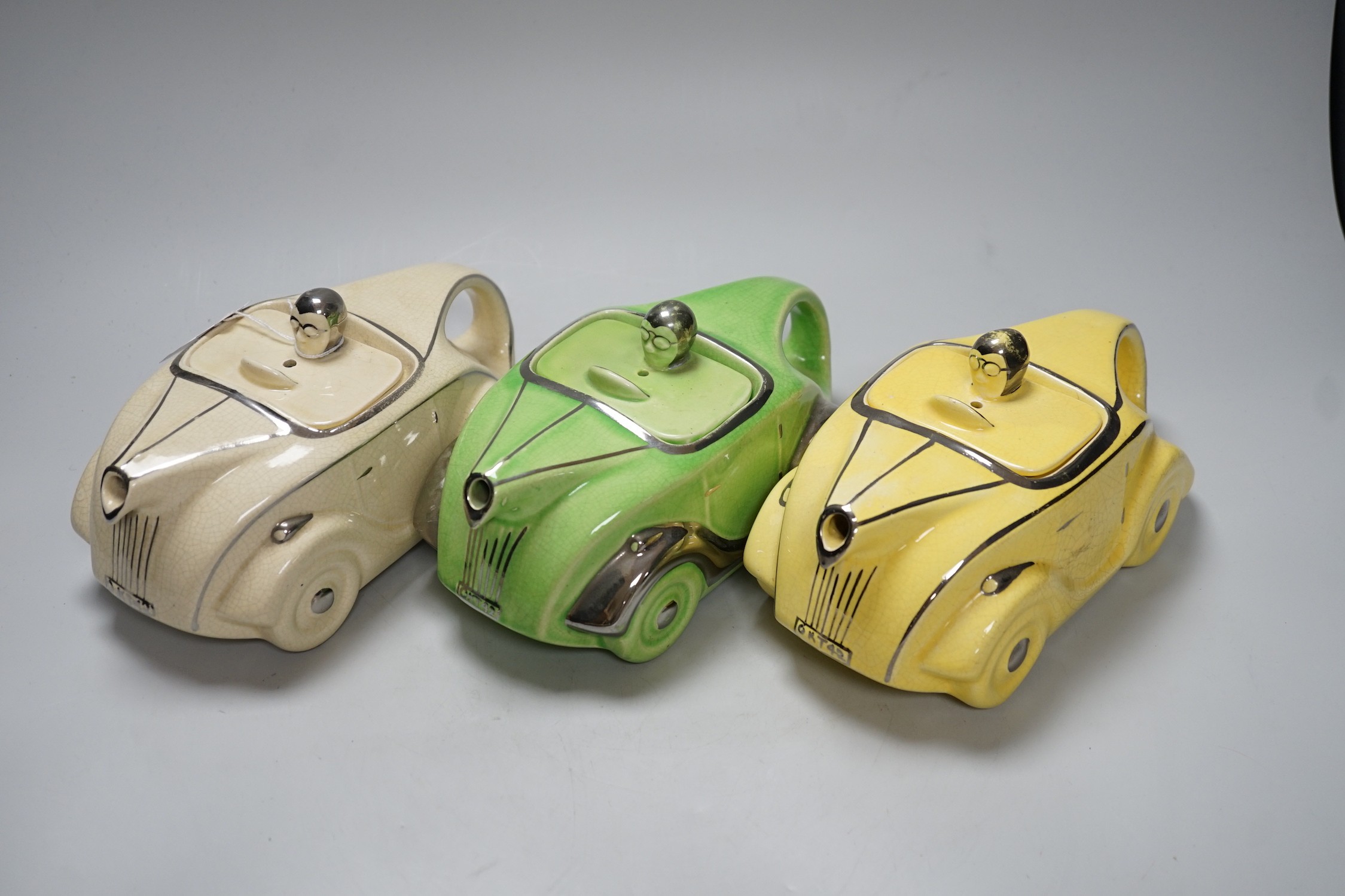 Three 1930s Art Deco Sadler racing car teapots, 22cm long